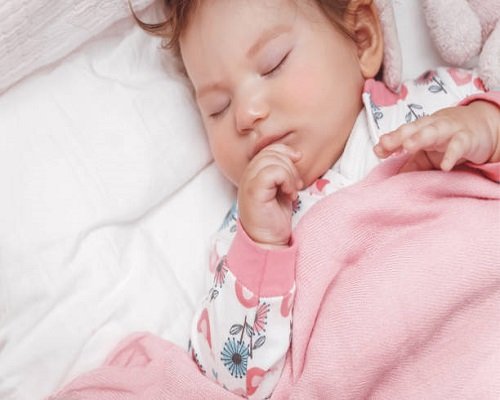 a Nice Little Baby Girl Peacefully Sleeping in the Crib at Home